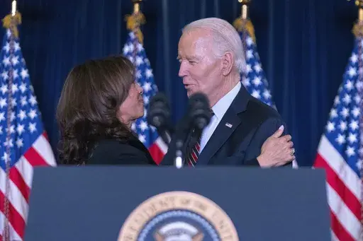 Vice President Kamala Harris, left, speaks with President Joe Biden at the Democratic National Committee's Holiday Reception at Willard Hotel in Washington, Sunday, Dec. 15, 2024. (AP Photo/Jose Luis Magana)