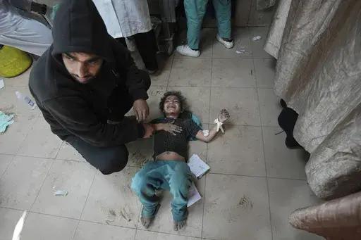 Palestinians wounded in the Israeli bombardment of the Gaza Strip are brought to Al Aqsa hospital in Deir al Balah, Gaza Strip, Friday, March 8, 2024. (AP Photo/Adel Hana)