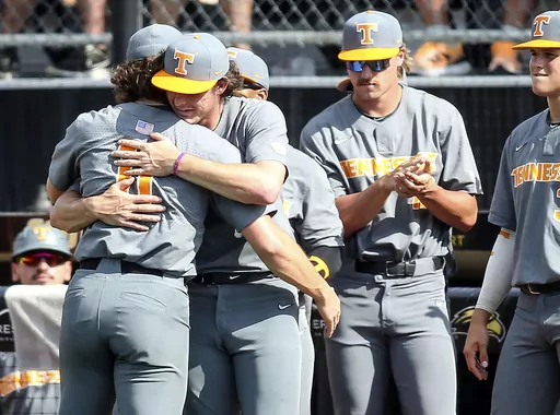 Tennessee starting pitcher Chase Dollander (11) is congratulated by teammates after leaving in the ninth inning against Southern Mississippi during an NCAA college baseball tournament super regional game in Hattiesburg, Miss., Sunday, June 11, 2023. (James Pugh/impact601.com via AP)