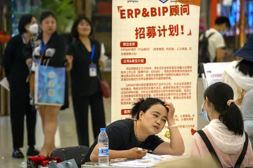 A recruiter talks with an applicant at a booth at a job fair at a shopping center in Beijing, on June 9, 2023. A record of more than one in five young Chinese are out of work, their career ambitions at least temporarily derailed by a depressed job market as the economy struggles to regain momentum after its long bout with COVID-19. (AP Photo/Mark Schiefelbein, File)