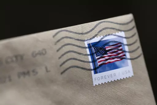 A stamp is shown on an envelope Friday, May 28, 2021, in Washington. When you receive an email or mail notice inviting you to join a class-action lawsuit, or notifying you that you’ve been automatically included, it might give you pause. Is it worth the small reward — usually under $20 — to give up your rights to sue individually? (AP Photo/Jenny Kane, File)