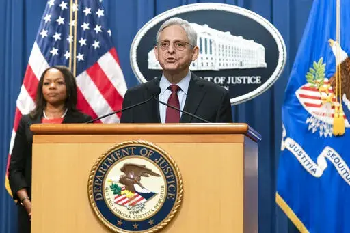 Attorney General Merrick Garland with Assistant Attorney General Kristen Clarke for the Civil Rights Division, speaks during a news conference at the Department of Justice in Washington, Thursday, Aug. 4, 2022. The U.S. Justice Department announced civil rights charges Thursday against four Louisville police officers over the drug raid that led to the death of Breonna Taylor, a Black woman whose fatal shooting contributed to the racial justice protests that rocked the U.S. in the spring and summ