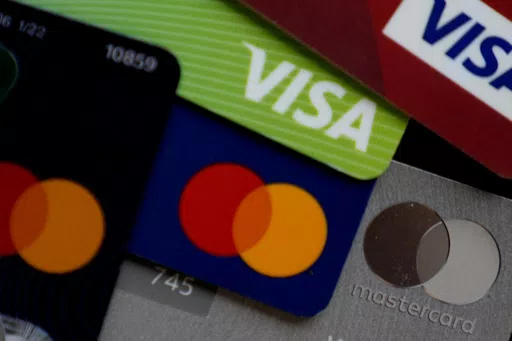 Several VISA and MASTER credit cards are shown in Buffalo Grove, Ill., Thursday, Feb. 8, 2024. Adding your child as an authorized user on your credit card can be a simple way to start building their credit file. But if the issuer doesn’t report account details to the credit bureaus or your account isn’t in good standing, their credit score won’t get enhanced. (AP Photo/Nam Y. Huh, File)