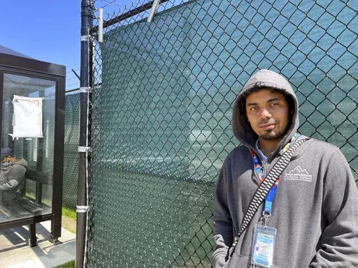 Alexander Campbell, a 25-year-old warehouse worker, stands by Amazon's LDJ5 warehouse in the Staten Island borough of New York on Friday, April 29, 2022.   The National Labor Relations Board will count votes Monday in the second union election among Amazon workers on Staten Island, New York, a rematch for the retailer and the nascent group of worker organizers right on the heels of their historic labor victory.  Campbell voted against the union, saying he read some things online that convinced h