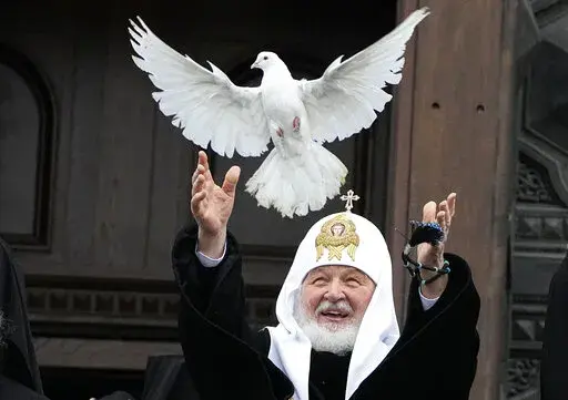 Russian Orthodox Church Patriarch Kirill releases a bird celebrating the Annunciation preceding the celebration of Orthodox Easter in front of the Christ the Savior Cathedral in Moscow, Russia, Thursday, April 7, 2022. (AP Photo/Alexander Zemlianichenko)