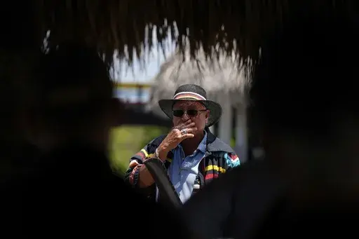 Miccosukee Tribal elder Michael Frank speaks to members of a task force that brings together federal, state, tribal and local agencies working to restore and protect the Florida Everglades, on a field visit to the Miccosukee Indian Reservation ahead of a task force meeting hosted by the Miccosukee Tribe, Wednesday, April 24, 2024. (AP Photo/Rebecca Blackwell)