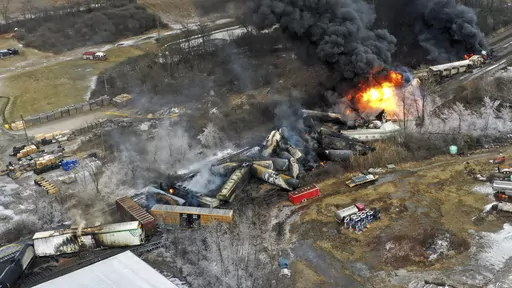 In this photo taken with a drone, portions of a Norfolk Southern freight train that derailed the previous night in East Palestine, Ohio, remain on fire at mid-day, Feb. 4, 2023. The Pipelines and Hazardous Materials Safety Administration proposed a new rule Wednesday, June 21, that would require all railroads to quickly provide the details of everything aboard their trains electronically to every emergency responder within 10 miles of a derailment. (AP Photo/Gene J. Puskar, File)