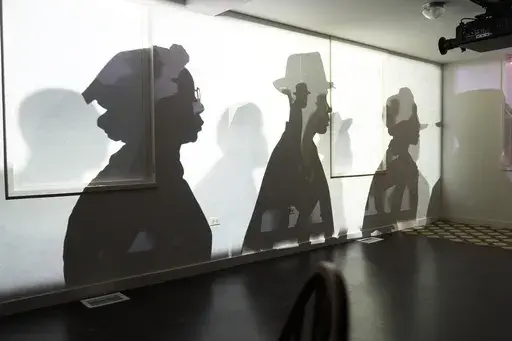 A video projection by Manual Cinema uses animation, shadow puppets and oral installation to help museum visitors "understand why more than 50 years after the Fair Housing Act of 1968, we are still living in a segregated world with a growing racial wealth gap," according to the National Public Housing Museum, Wednesday, March 19, 2025, in Chicago. (AP Photo/Erin Hooley)