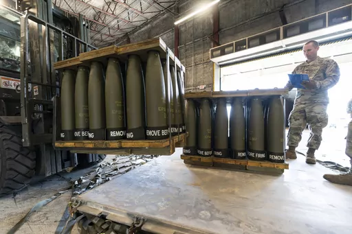 U.S. Air Force Staff Sgt. Cody Brown, right, with the 436th Aerial Port Squadron, checks pallets of 155 mm shells ultimately bound for Ukraine, April 29, 2022, at Dover Air Force Base, Del. On Sept. 15, 2023, The Associated Press reported on a false claim online that the U.S. accidentally sent Ukraine $6 billion in military aid. The claim misrepresents remarks by a Pentagon spokesperson. (AP Photo/Alex Brandon, File)