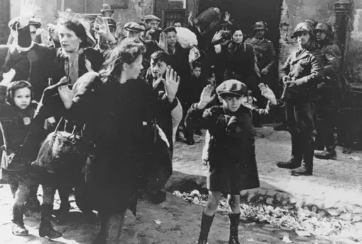 A group of Jews, including a small boy, is escorted from the Warsaw Ghetto by German soldiers on April 19, 1943. (AP Photo, File)