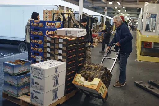 People shop for fruits and vegetables at S. Katzman Produce at the Hunts Point Produce Market on Tuesday, Nov. 22, 2022, in the Bronx borough of New York. On Tuesday, Dec. 13, the Labor Department reports on U.S. consumer prices for November. (AP Photo/Andres Kudacki, File)