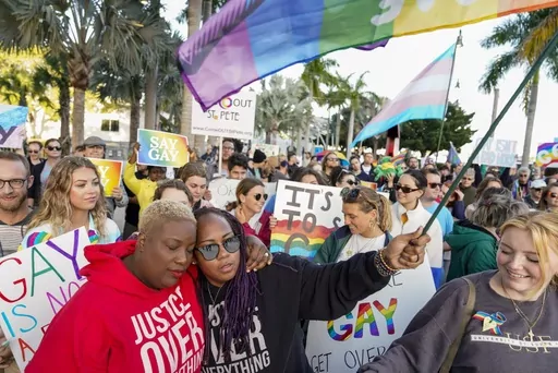 Florida House Representative Michele Rayner, left, hugs her spouse, Bianca Goolsby, during a march at city hall in St. Petersburg, Fla., on March 12, 2022, to protest the controversial "Don't Say Gay" bill passed by Florida's Republican-led legislature. While Florida has received national attention for what opponents call the "Don't Say Gay" law, the trend is national, particularly in red states. The American Civil Liberties Union is tracking nearly 470 bills it considers to be anti-LGBTQ+, most