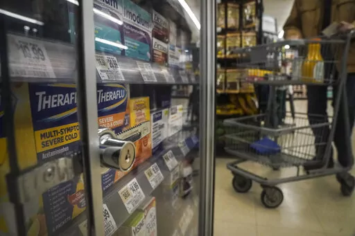 Pharmaceutical items are kept locked in a glass cabinet at a Gristedes supermarket, Tuesday Jan. 31, 2023, in New York. Increasingly, retailers are locking up more products or increasing the number of security guards at their stores to curtail theft. (AP Photo/Bebeto Matthews)