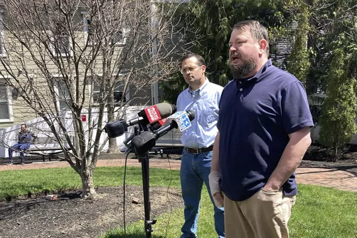 Sean Halsey, right, who was injured along with his children in a shooting in Maine last week, speaks at a news conference outside Maine Medical Center in Portland, Maine, Friday, April 28, 2023. Halsey said he and his children are recovering from their injuries and grateful for the support they've received from the community. A 34-year-old man confessed last week to four killings at a home in Bowdoin and injuring the three people while shooting at vehicles on Interstate 295 in Yarmouth, police h