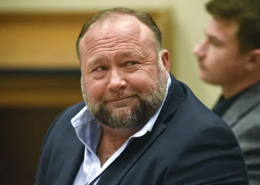 Infowars founder Alex Jones appears in court to testify during the Sandy Hook defamation damages trial at Connecticut Superior Court in Waterbury, Conn., on Thursday, Sept. 22, 2022. Jones and his company have been ordered to pay an extra $473 million to families and an FBI agent for calling the 2012 Sandy Hook school shooting a hoax. (Tyler Sizemore/Hearst Connecticut Media via AP, Pool, File)
