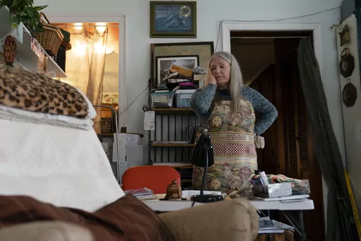 Nancy Rose, who contracted COVID-19 in 2021 and exhibits long-haul symptoms including brain fog and memory difficulties, pauses while organizing her desk space, Tuesday, Jan. 25, 2022, in Port Jefferson, N.Y. Rose, 67, said many of her symptoms waned after she got vaccinated, though she still has bouts of fatigue and memory loss. U.S. health officials estimate 3.3 million Americans have chronic fatigue syndrome — a bigger number than previous studies have suggested, and one likely boosted by p