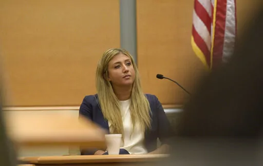 Brittany Paz, a lawyer hired by Alex Jones to testify about his companies, is questioned by plaintiff's attorney Chris Mattei during Jones' Sandy Hook defamation damages trial in Superior Court in Waterbury, Conn., on Thursday, Sept. 15, 2022. (H John Voorhees III/Hearst Connecticut Media via AP, Pool)