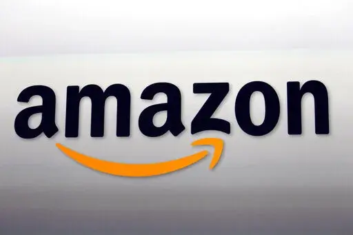 The Amazon logo in Santa Monica, Calif., Sept. 6, 2012. More than 700 Amazon warehouse workers in England staged a protest Thursday, Aug. 4, 2022,  in a dispute over pay. It's the latest sign of workplace friction stoked by Britain’s cost of living crisis and the growing discontent among Amazon's warehouse workers over wage and working conditions. (AP Photo/Reed Saxon, File)