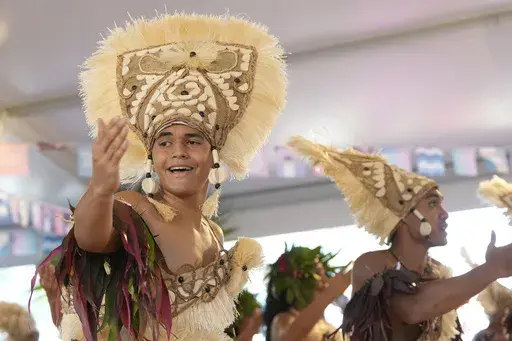 Dancers perform during an opening ceremony for the 2024 Summer Olympics surfing competition Friday, July 26, 2024, in Papara, Tahiti. (AP Photo/Gregory Bull)