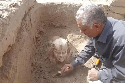In this undated photo distributed Monday, March 6, 2023, by the Egyptian Ministry of Tourism and Antiquities, a sphinx statue believed to be made in the likeness of a Roman emperor is uncovered from an archaeological site in Qena, Egypt. The site that also contains a shrine to the Ancient Egyptian god Horus dating back to the Roman era, according to the country’s top antiquities official Mostafa Waziri. Waziri also said in a statement that initial examinations point to the statue being modeled