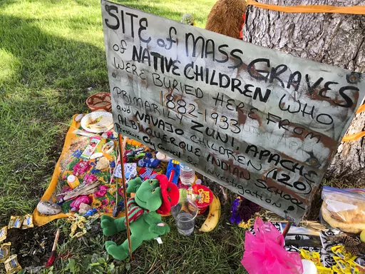 A makeshift memorial for the dozens of Indigenous children who died more than a century ago while attending a boarding school that was once located nearby is displayed under a tree at a public park in Albuquerque, N.M., on  July 1, 2021. The U.S. Interior Department is expected to release a report Wednesday, May 11, 2022, that it says will begin to uncover the truth about the federal government's past oversight of Native American boarding schools. (AP Photo/Susan Montoya Bryan, File)