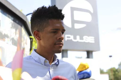 Brandon Wolf, a survivor of the Pulse nightclub shooting and activist, stands outside of the Pulse memorial in Orlando, Fla., on Sept. 9, 2022. After mass shootings, the loss felt by marginalized groups already facing discrimination is compounded. Some public health experts say the risk for post-traumatic stress disorder is greater for the groups, especially when the shootings take place at schools, churches and other vital hubs. (AP Photo/Cody Jackson)