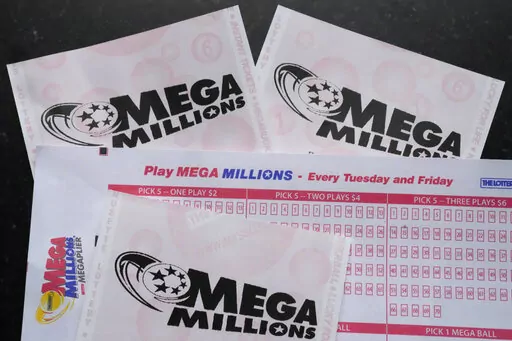 Mega Millions lottery tickets and a wager slip are displayed, Friday, Jan. 6, 2023, in Derry, N.H. An estimated $1.1 billion Mega Millions jackpot drawing Tuesday, Jan. 10, 2023, has people lined up at convenience stores nationwide to buy tickets in longshot hopes of winning a massive prize, but shop and gas station owners selling the tickets also have a chance at a big-figure bonus. (AP Photo/Charles Krupa, File)