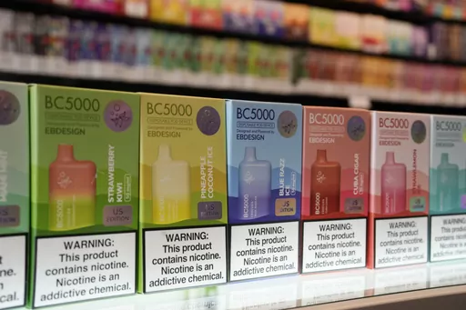 Varieties of disposable flavored electronic cigarette devices manufactured by EB Design, formerly known as Elf Bar, are displayed at a store in Pinecrest, Fla., Monday, June 26, 2023. A report released by the Centers for Disease Control and Prevention on Thursday, Nov. 2, 2023, shows fewer high school students are vaping. About 10% of high school students said they used electronic cigarettes in the previous month, down from 14% from the same survey conducted last year. Fewer high schools student