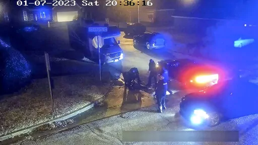 In this image from video released and partially redacted by the city of Memphis, Tenn., Tyre Nichols lies on the ground during a brutal attack by Memphis Police officers, Jan. 7, 2023, in Memphis. Documents released Thursday, March 2, showed that two Memphis Fire Department emergency medical technicians who were fired and had their licenses suspended for failing to give aid to Nichols for 19 minutes while he struggled with injuries from being brutally beaten by police did not check his vital sig