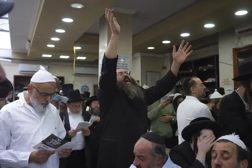 Orthodox Jews pray at the tomb of Rabbi Nachman, the great grandson of the founder of Hasidic movement, in the town of Uman, 200 kilometers (125 miles) south of Ukraine's capital Kiev, Ukraine, Sunday, Sept. 25, 2022. Thousands of Hasidic Jewish pilgrims flocked to central Ukraine to mark the Jewish new year Sunday, ignoring international travel warnings as Russia struck more targets from the air and mobilized its citizens to stem losses in the war that has entered its eighth month. (AP Photo/Ef