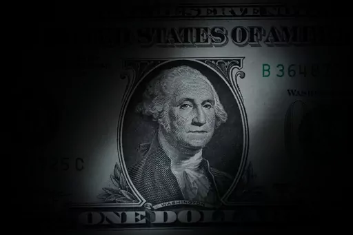 The likeness of George Washington is seen on a U.S. one dollar bill, Monday, March 13, 2023, in Marple Township, Pa. While credit scores aren’t exactly the most romantic topic of discussion, they can be the keys to unlocking the future that you and your partner envision. Chatting about scores with a significant other is also a good way to learn about their money history and behaviors. (AP Photo/Matt Slocum, File)