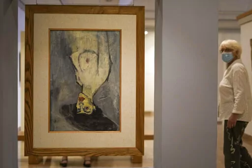 Amadeo Modigliani's 1908 "Nude with a Hat," is hung upside down because another painting by him, "Maud Abrantes," on the reverse side of the same canvas is oriented correctly, while on display at Haifa University's Hecht Museum in Haifa, Israel, June 28, 2022. Curators at the museum using x-ray technology have discovered three previously unknown sketches by the celebrated 20th century artist hiding beneath the surface of the painting. (AP Photo/Ariel Schalit)