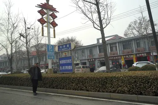 A man walks along the road in the city of Handan in northern China's Hebei province on Feb. 28, 2024. Chinese authorities in the Feixiang district near Handan city announced three suspects have been detained over the March 10, 2024 gruesome murder of a thirteen-year-old boy, riveting users on Chinese social media and sparking debate over bullying and mental health in China's countryside. (AP Photo/Emily Wang Fujiyama, File)