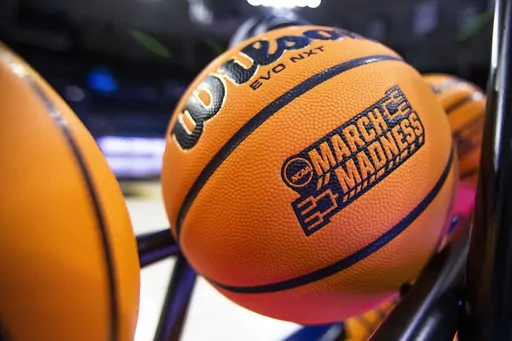 A basketball with a March Madness logo rests on a rack before a First Four game between Illinois and Mississippi State in the NCAA women's basketball tournament Wednesday, March 15, 2023, in South Bend, Ind. An estimated 68 million Americans are expected to place bets on this years NCAA Men’s Basketball Tournament. And with a recent explosion in legalized online sports gambling across the United States, the opportunities to bet on this year’s bracket will reach far beyond your office pool. (