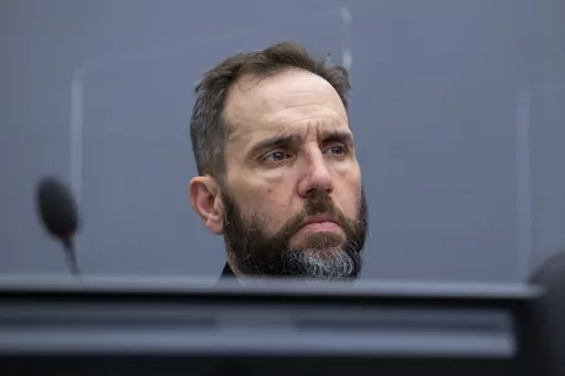 Prosecutor Jack Smith waits for the start of the court session of Kadri Veseli's initial appearance at the Kosovo Specialist Chambers court in The Hague, Netherlands, Nov. 10, 2020. Smith, the prosecutor named as special counsel to oversee investigations related to former President Donald Trump, has a long career confronting public corruption and war crimes. (AP Photo/Peter Dejong, Pool, File)