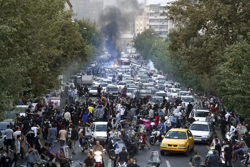 In this photo taken by an individual not employed by the Associated Press and obtained by the AP outside Iran, protesters chant slogans during a protest over the death of a woman who was detained by the morality police, in downtown Tehran, Iran, Sept. 21, 2022. Iran’s Foreign Ministry said Sunday, Sept. 25, 2022, that it summoned Britain's ambassador to protest what it described as a hostile atmosphere created by London-based Farsi language media outlets. The move comes amid violent unrest in 