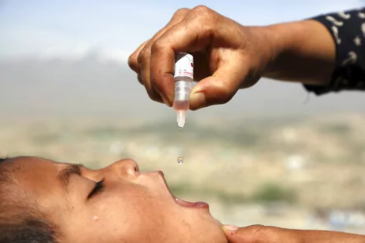 An Afghan health worker uses an oral polio vaccine on a child as part of a campaign to eliminate polio, on the outskirts of Kabul, Afghanistan, April 18, 2017. For years, global health officials have used billions of drops of an oral vaccine in a remarkably effective campaign aimed at wiping out polio in its last remaining strongholds — typically, poor, politically unstable corners of the world. Now, in a surprising twist in the decades-long effort to eradicate the virus, authorities in Jerusa