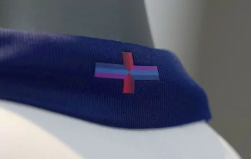 A view of Nike's designed St George's Cross on the back of the collar of the new England shirt at St. George's Park, Burton upon Trent, England, Friday March 22, 2024. England's new men's soccer team shirt is out and it's causing a bit of a stir. And it's not just the price that's vexing some. The decision by Nike to change the color of the St. George’s Cross on the new shirt from the traditional red and white has even prompted the prime minister and the man who is favored to succeed him to ma