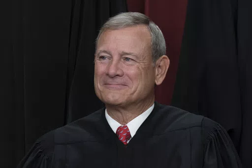 Chief Justice of the United States John Roberts joins other members of the Supreme Court as they pose for a new group portrait, at the Supreme Court building in Washington, Oct. 7, 2022. Roberts has declined an invitation to meet with Democratic senators to talk about Supreme Court ethics and the controversy over flags that flew outside homes owned by Justice Samuel Alito. (AP Photo/J. Scott Applewhite, File)