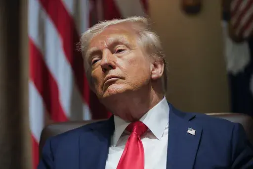 President Donald Trump listens during a Cabinet meeting at the White House in Washington, Wednesday, Feb. 26, 2025. (Pool via AP)