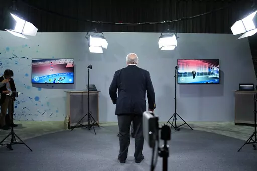 An attendee stands between cameras used to live broadcast into the metaverse during a Sony news conference before the start of the CES tech show Wednesday, Jan. 4, 2023, in Las Vegas. (AP Photo/John Locher)