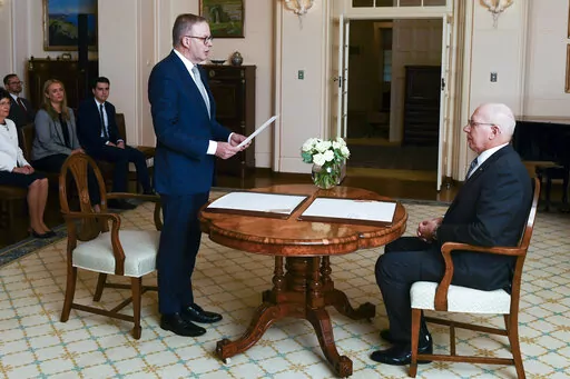 Anthony Albanese is sworn in as Australia's Prime Minister by Australian Governor-General David Hurley, right, during a ceremony at Government House in Canberra, Monday, May 23, 2022. Albanese has been sworn in ahead of a Tokyo summit while vote counting continues to decide whether he will control a majority in a Parliament that is demanding tougher action on climate change. (Lukas Coch/AAP Image via AP)