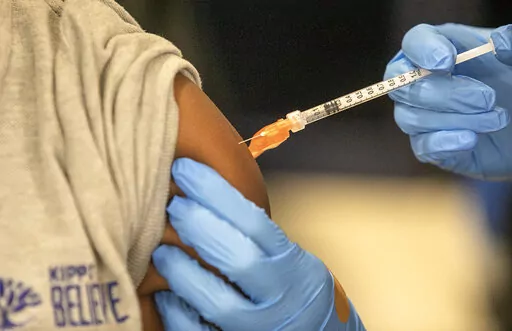 Medical personnel vaccinate students at a school in New Orleans on Tuesday, Jan. 25, 2022. U.S. data suggests it is unlikely that COVID-19 vaccines might trigger a rare inflammatory condition linked with the virus in children, according to a study published Tuesday, Feb. 22. Researchers from the CDC and other institutions analyzed vaccine surveillance data in their study, published in The Lancet Child & Adolescent Health. (AP Photo/Ted Jackson, File)
