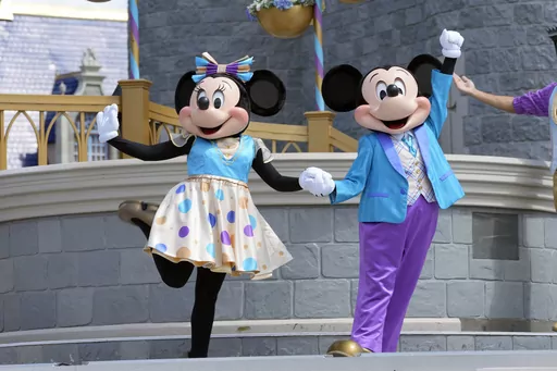 Minnie and Mickey Mouse perform for guests during a musical show in the Magic Kingdom at Walt Disney World, July 14, 2023, in Lake Buena Vista, Fla. Disney has requested a second court delay in its legal battle with Florida Gov. Ron DeSantis’ appointees over who controls Walt Disney World’s governing district. The request this week comes as the company is accusing the appointees and the governor’s office of failing to produce documents it had requested as part of the litigation. (AP Photo/