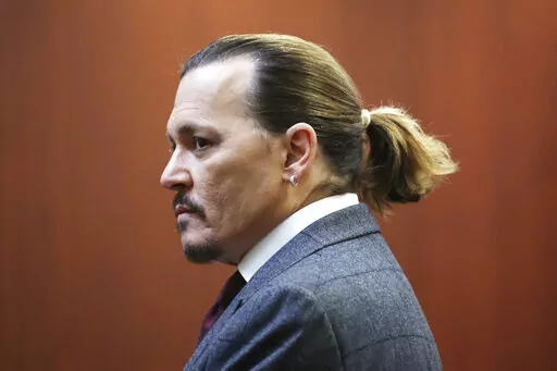 Actor Johnny Depp arrives in the courtroom at the Fairfax County Circuit Court in Fairfax, Va., Thursday, April 28, 2022. Actor Johnny Depp sued his ex-wife actor Amber Heard for libel in Fairfax County Circuit Court after she wrote an op-ed piece in The Washington Post in 2018 referring to herself as a "public figure representing domestic abuse." (Michael Reynolds/Pool Photo via AP)