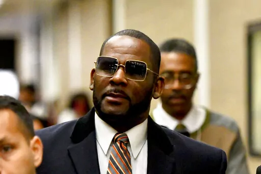 Musician R. Kelly, center, leaves the Daley Center after a hearing in his child support case on May 8, 2019, in Chicago. A Chicago prosecutor said Monday, Jan. 30, 2023, that she's dropping sex-abuse charges against singer R. Kelly, following federal convictions in two courts that ensure the disgraced R&B star will be locked up for decades.(AP Photo/Matt Marton, File)