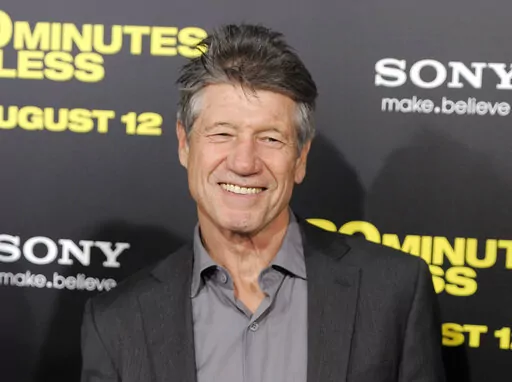 Fred Ward, a cast member in "30 Minutes or Less," poses at the premiere of the film in Los Angeles on Aug. 8, 2011. Ward, a veteran actor who brought a gruff tenderness to tough-guy roles in such films as “The Right Stuff,” “The Player” and “Tremors,” died Sunday, May 8, his publicist Ron Hofmann said Friday, May 13, 2022. He was 79. (AP Photo/Chris Pizzello, File)