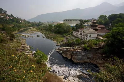 The polluted Bagmati River flows to an exit point from Kathmandu, Nepal, Tuesday, April 26, 2022. Tainted by garbage and raw sewage that is dumped directly into the waterway, Nepal’s holiest river has deteriorated so greatly that today it is also the country’s most polluted, dramatically altering how the city of about 3 million interacts with the Bagmati on daily, cultural and spiritual levels. (AP Photo/Niranjan Shrestha)