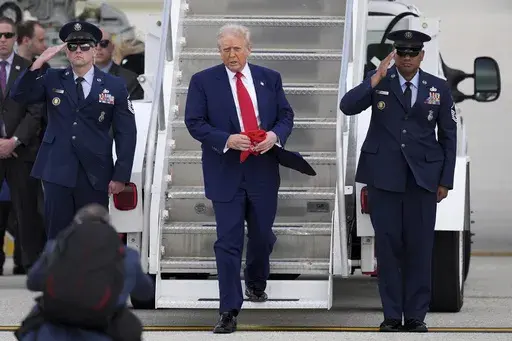 President Donald Trump, center, arrives on Air Force One at Miami International Airport, Thursday, April 3, 2025, in Miami. (AP Photo/Rebecca Blackwell)