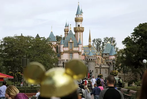 Visitors walk toward Sleeping Beauty's Castle in the background at Disneyland Resort on Jan. 22, 2015, in Anaheim, Calif. Disney CEO Bob Iger on Monday, April 3, 2023, called efforts by Florida Gov. Ron DeSantis and the Republican-controlled Florida Legislature to retaliate against the company for its policy positions as not only “anti-business but anti-Florida.” (AP Photo/Jae C. Hong, File)